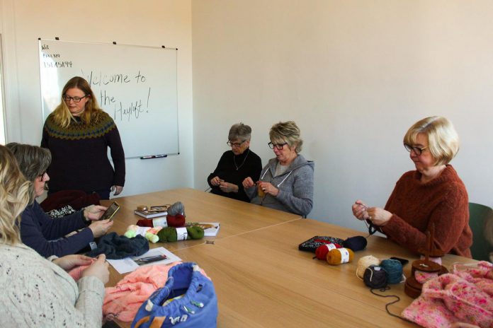 Deanna Guttman, owner of Needles in the Hay in downtown Peterborough, leads a beginner knitting workshop in The Hayloft, a supportive workshop space located above the Water Street fibre arts supply store. In early 2026, Guttman will be launching new multi-day beginner knitting and crochet courses to guide new fibre artists on the basics of the craft. (Photo courtesy of Needles in the Hay)