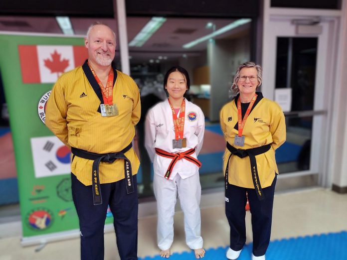 Linda Touzin (right) of Blue Wave Taekwondo in Peterborough with a silver medal in female black belt poomsae at the 2025 Toronto Open Taekwondo Championships on November 16, 2025. Also pictured are Alan Prodonick, who won gold in male black belt sparring and silver in male black belt po0msae, and Ada Tsoi, who won gold in female black stripe poomsae and silver in female black stripe sparring. (Photo courtesy of Blue Wave Taekwondo)
