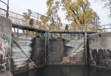 Parks Canada is replacing the upper and lower lock gates at Lock 20 - Ashburnham in Peterborough from November 2025 through April 2026. As pedestrians using the Trans Canada Trail normally cross the lock via the yellow bridge at the top of the lock gates, Parks Canada will be installing a temporary bridge to allow pedestrian access to the trail during the construction period. (Photo: Bruce Head / kawarthaNOW)