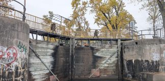 Parks Canada is replacing the upper and lower lock gates at Lock 20 - Ashburnham in Peterborough from November 2025 through April 2026. As pedestrians using the Trans Canada Trail normally cross the lock via the yellow bridge at the top of the lock gates, Parks Canada will be installing a temporary bridge to allow pedestrian access to the trail during the construction period. (Photo: Bruce Head / kawarthaNOW)