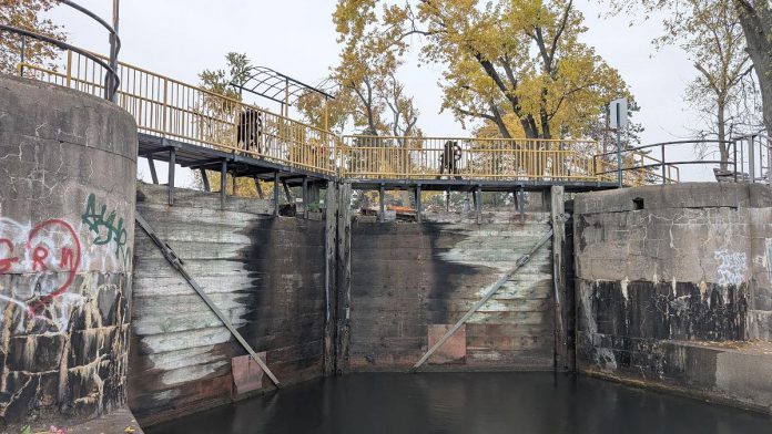 Parks Canada is replacing the upper and lower lock gates at Lock 20 - Ashburnham in Peterborough from November 2025 through April 2026. As pedestrians using the Trans Canada Trail normally cross the lock via the yellow bridge at the top of the lock gates, Parks Canada will be installing a temporary bridge to allow pedestrian access to the trail during the construction period. (Photo: Bruce Head / kawarthaNOW) Parks Canada is replacing the upper and lower lock gates at Lock 20 - Ashburnham in Peterborough from November 2025 through April 2026. As pedestrians using the Trans Canada Trail normally cross the lock via the yellow bridge at the top of the lock gates, Parks Canada will be installing a temporary bridge to allow pedestrian access to the trail during the construction period. (Photo: Bruce Head / kawarthaNOW)