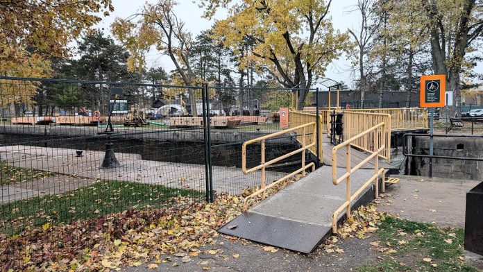 Construction fencing is in place at Lock 20 - Ashburnham in Peterborough in advance of a Parks Canada project to replace the upper and lower lock gates from November 2025 through April 2026. Access to the Trans Canada Trail across the lock will be temporarily closed on November 7, 2025 so Parks Canada can install a temporary bridge to allow pedestrian access to the trail during the construction period. (Photo: Bruce Head / kawarthaNOW)