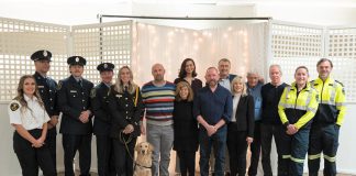 Wilfred Vienot (seventh from right), who suddenly collapsed in his home one day last year after suffering a cardiac arrest and was resuscitated thanks to community members and first responders, attended Northumberland County's 10th annual "Survivor Night" on October 27, 2025 with first responders from Lindsay Central Ambulance Communications Centre, Cobourg Fire Department, Northumberland Paramedics, and his neighbours and friends. (Photo: Northumberland County)