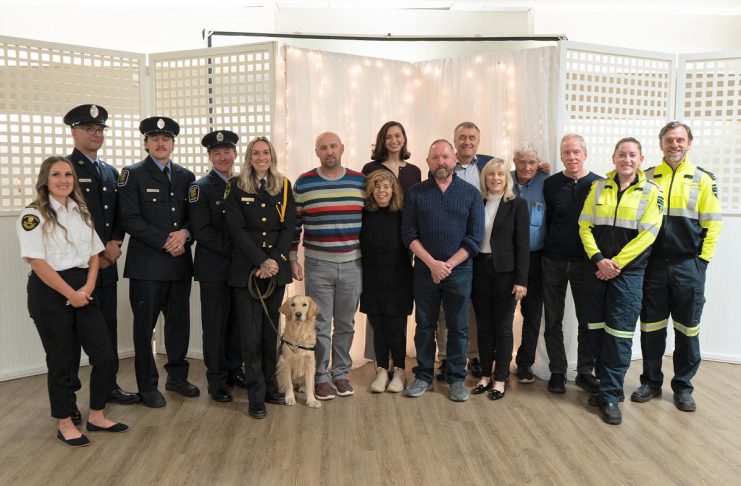Wilfred Vienot (seventh from right), who suddenly collapsed in his home one day last year after suffering a cardiac arrest and was resuscitated thanks to community members and first responders, attended Northumberland County's 10th annual "Survivor Night" on October 27, 2025 with first responders from Lindsay Central Ambulance Communications Centre, Cobourg Fire Department, Northumberland Paramedics, and his neighbours and friends. (Photo: Northumberland County)