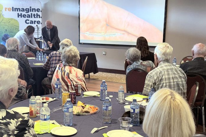 During a September 2025 donor celebration event, Peterborough Regional Health Centre (PRHC) interventional cardiologist and head of cardiology Dr. Warren Ball showed donors how their gifts to the upgraded cardiac cath lab suites at the regional hospital have had lifesaving impact on patients by dramatically shortening the time for even the most complex procedures. (Photo courtesy of PRHC Foundation)