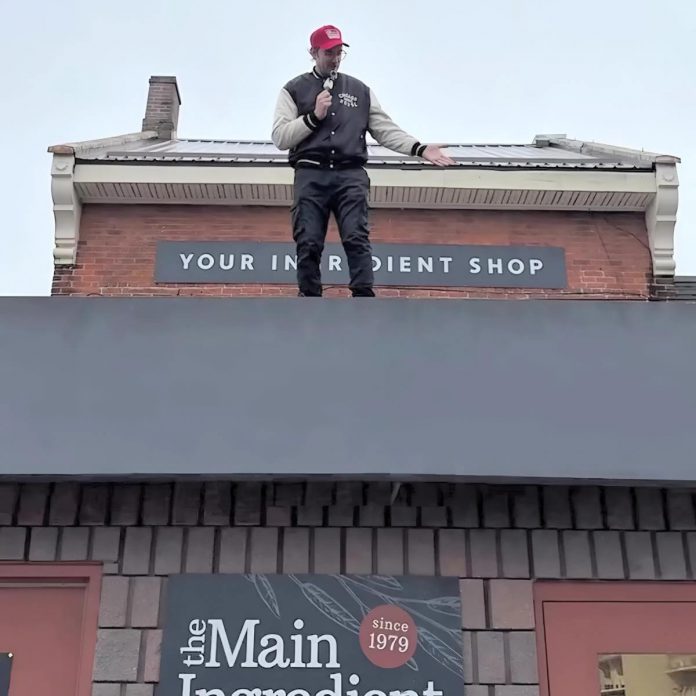 Michael Hall, who owns The Main Ingredient along with his wife Whitney, stands on the roof of the bulk food store at 326 Charlotte Street in downtown Peterborough. With the support of local businesses, the couple is hosting a special in-store event from 5 to 8 p.m. on November 8, 2025 to raise $10,000 for essential roof repairs. (Photo: The Main Ingredient / Instagram)
