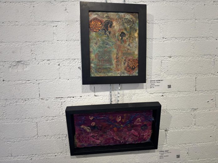 Shawn Hamilton is one of the member artists who have work priced under $50 in the Christmas in the Annex exhibition being held at A Place for the Arts in Bancroft until December 28, 2025. Though Hamilton got her start as an equine photographer, the exhibition gives her the opportunity to explore and see the public response to a new encaustic and mixed media style. (Photo: Megan Gallant / kawarthaNOW)