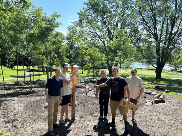 David Hughes (left), assistant superintendent for Peterborough Golf and Country Club, worked with Thomas A. Stewart Secondary School's woodworking class earlier in 2025 to build butterfly houses in what has since become a pollinator garden next to the 14th green. (Photo: Kevin Kobzan / Peterborough Golf and Country Club)