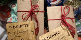 Rethinking the gift wrap: reducing holiday waste without reducing the joy Thoughtfully chosen and long-lasting materials can replace single-use options for gift giving without sacrificing the festive spirit. Not only are these gifts wrapped in non-glossy paper and decorated with non-plastic bows, the gift tags are carved into wood and offer a keepsake in of themselves. (Photo: Natalie Stephenson / GreenUP)