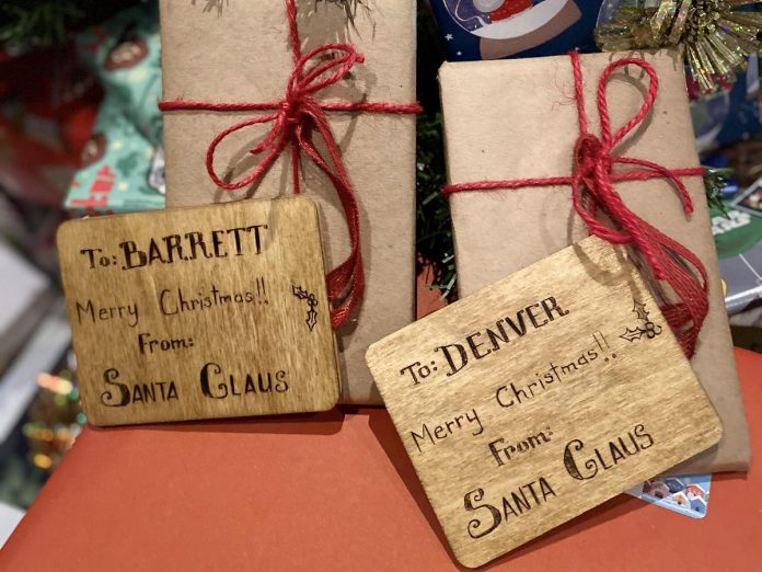 Thoughtfully chosen and long-lasting materials can replace single-use options for gift giving without sacrificing the festive spirit. Not only are these gifts wrapped in non-glossy paper and decorated with non-plastic bows, the gift tags are carved into wood and offer a keepsake in of themselves. (Photo: Natalie Stephenson / GreenUP)