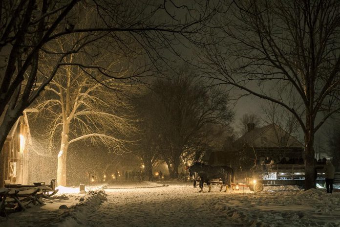 A horse-drawn wagon ride through Lang Pioneer Village Museum in Keene is one of the many activities available during the family-friendly "Christmas by Candlelight" event taking place from 4 to 8 p.m. on December 6 and 7, 2025. (Photo: Heather Doughty Photography)