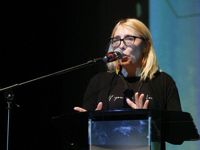 ReFrame Film Festival board chair Melanie Buddle speaks to audiences during the 2025 festival in downtown Nogojiwanong/Peterborough. She says the festival brings "a bright light at the end of January" to winter-weary audiences, and is encouraging longtime festival-goers to bring a young person with them this year. (Photo courtesy of ReFrame Film Festival)