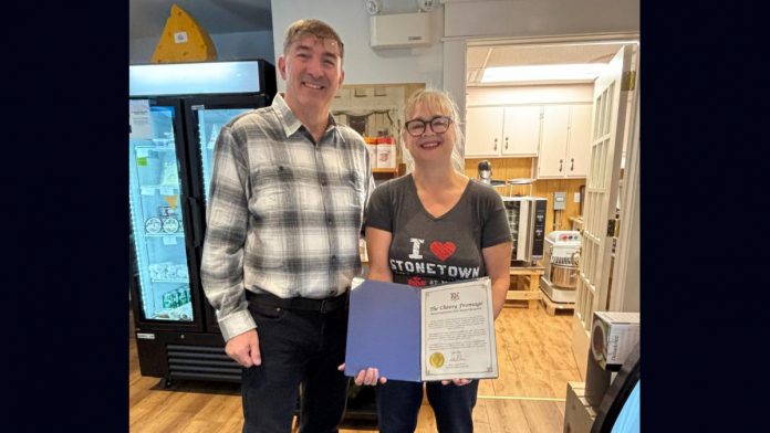 Peterborough-Kawartha MPP Dave Smith with Cheesy Fromage owner Tanya Bailey and her Rural Entrepreneur award from Ontario's Ministry of Rural Affairs. The Lakefield business owner was formally presented with the inaugural award as part of the first Rural Inspiration Awards event at the Rural Ontario Municipalities Association (ROMA) conference in Toronto on January 19, 2026. (Photo: Office of Dave Smith)