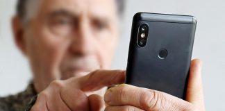 Cobourg police remind public to be vigilant after 82-year-old man nearly loses savings in bank investigator scam An elderly man using a cell phone. (Stock photo)