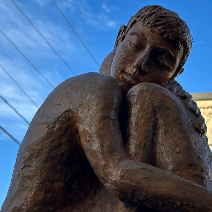 "Embrace" (2018, clay, patina, acrylic sealer) by Rosalinde Baumgartner was one of the sculptures chosen for the 2025 Downtown Sculpture Exhibition held by the Fenelon Arts Committee and City of Kawartha Lakes. Submissions are now open for the 2026 public art exhibition which will be on display in planters in downtown Fenelon Falls between May and October 2026. (Photo: Fenelon Arts Committee / Facebook)