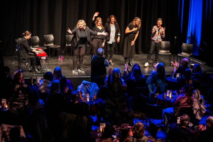 As Jordan Armstrong provides musical accompaniment, Jennine Profeta, Karen Parker, Linda Kash, Diana Frances, and Elvira Kurt wave to the audience at the end of a Girls Nite Out show at Market Hall Performing Arts Centre in downtown Peterborough on January 16, 2025. Since it was first performed at Globus Theatre in Bobcaygeon two decades ago, the all-female comedy ensemble has been touring across Canada to much acclaim. (Photo: Dahlia Katz)