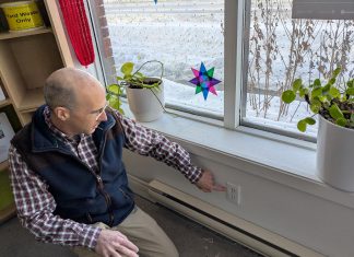 Lower your heating bills and stay warm by sealing air leaks in your home GreenUP energy advisor Bryn Magee points to an electrical outlet on an exterior wall in the GreenUP office. In many older buildings, electrical outlets are sources of air leakage. Foam gaskets and plug protectors can help to staunch the flow of cold air. (Photo: Clara Blakelock / GreenUP)