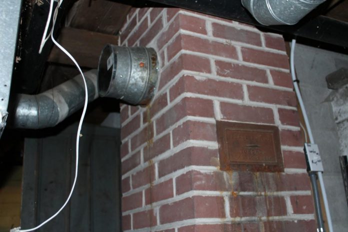 Basements are often treasure troves of hidden air leakage. Capped off venting and unused chimneys can allow cold air to enter the home. In an unfinished basement, addressing air leaks can be as simple as using spray foam, caulking, or concrete to fill in gaps. (Photo: Bryn Magee / GreenUP)