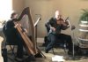 Harpist Tanah Haney and fiddler John Hoffman, pictured performing as the duo Banish Misfortune, will be joined by cellist Jessica Lindeman for a free family-friendly Robbie Burns Day concert on January 25, 2026 at Camp Kawartha Environment Centre in Peterborough. The trio will perform Scottish airs, waltzes, jigs, and reels, as well as well-known Scottish songs including "Wild Mountain Thyme," "The Parting Glass," and "Auld Lang Syne" with lyrics by the beloved Scottish poet. (Photo courtesy of John Hoffman)