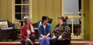 Colleen White-Goodchild as Suzanne, Lindsay Wilson as Beth, and Lyndele Gucci as Glenda during a rehearsal for the Peterborough Theatre Guild's production of "Where You Are" by Canadian playwright Kristen Da Silva, which runs for 10 performances from January 16 to 31, 2026. In the touching family comedy, sisters Suzanne and Glenda are enjoying their retirement on Manitoulin Island as veterinarian neighbour Patrick (Kevin O'Neill, not pictured) helps them out when Suzanne's doctor daughter Beth comes to Toronto for a visit, resulting in a budding romance between Patrick and Beth and the revelation of more than one family secret. (Photo: Jordan Lyall Photography)