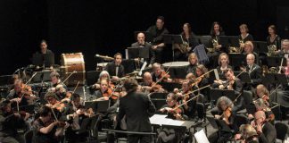 Michael Newnham conducting the Peterborough Symphony Orchestra (PSO) during the sold-out "Popcorn, Please!" concert in 2024. Newnham and the PSO return to Showplace Performance Centre in downtown Peterborough on February 7 and 8, 2026 for "Stars of the Silver Screen," the orchestra's third annual film music concert, this time featuring music from films of the 1960s including James Bond, The Pink Panther, Psycho, The Sound of Music, and many more. Audiences are encouraged to help set the mood by dressing in their favourite '60 outfits. (Photo courtesy of the PSO)