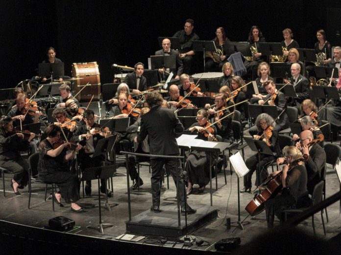 Michael Newnham conducting the Peterborough Symphony Orchestra (PSO) during the sold-out "Popcorn, Please!" concert in 2024. Newnham and the PSO return to Showplace Performance Centre in downtown Peterborough on February 7 and 8, 2026 for "Stars of the Silver Screen," the orchestra's third annual film music concert, this time featuring music from films of the 1960s including James Bond, The Pink Panther, Psycho, The Sound of Music, and many more. Audiences are encouraged to help set the mood by dressing in their favourite '60 outfits. (Photo courtesy of the PSO)