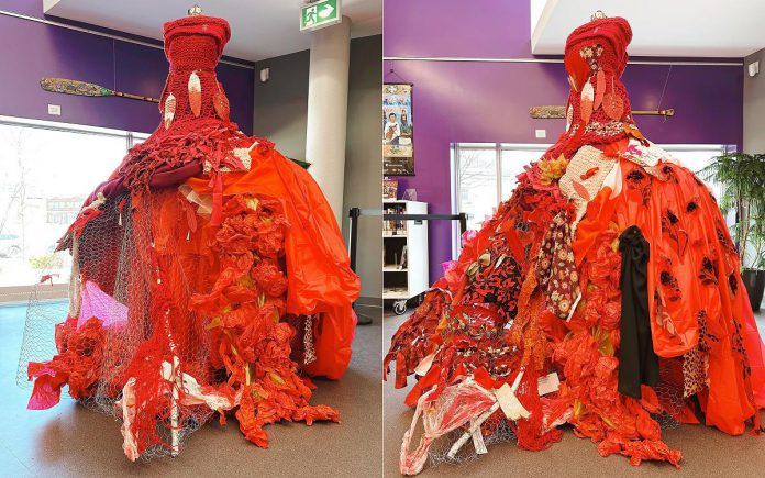 Ash Street, a Michi Saagiig artist of Nogojiwanong/Peterborough and Hiawatha First Nation, created the initial piece for "The Red Dress: A Community Art Installation" in April 2025 at the Peterborough Public Library and invited community members to fill in open spaces on the dress with donated textiles and materials on hand. The exhibit is now installed in the main foyer of Peterborough City Hall. (Photos: Peterborough Public Library) Ash Street, a Michi Saagiig artist of Nogojiwanong/Peterborough and Hiawatha First Nation, created the initial piece for "The Red Dress: A Community Art Installation" in April 2025 at the Peterborough Public Library and invited community members to fill in open spaces on the dress with donated textiles and materials on hand. The exhibit is now installed in the main foyer of Peterborough City Hall. (Photos: Peterborough Public Library)