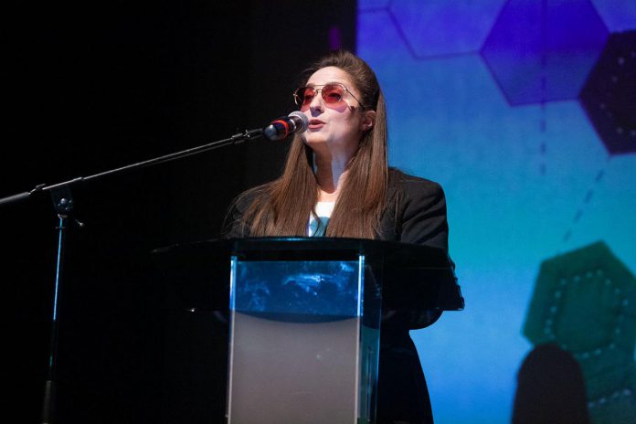 ReFrame Film Festival's executive director Kait Dueck speaks to the audience at the 2025 documentary film festival. Believing that "art is not a luxury," Dueck encourages community members to participate in the 2026 festival running in-person in downtown Peterborough from January 30 to February 1 and online across Canada from February 3 to 8. As well as providing shared experiences related to social and environmental justice, the festival generates hundreds of thousands of dollars for the local economy. (Photo courtesy of ReFrame Film Festival)