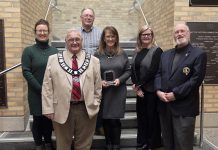 Stephanie Jukes (middle) accepting the Osprey Heritage Award for Heritage Restoration/Adaptive Reuse for the Saucy Willow Inn in Coboconk at Kawartha Lakes City Hall on January 13, 2026. Stephanie and her husband David (not pictured) purchased the historic 1878 building in 2021 and have since restored it. (Photo courtesy of City of Kawartha Lakes)