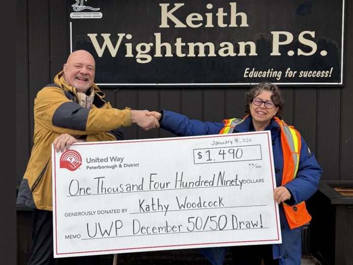 United Way Peterborough & District CEO Jim Russell presents a cheque to Kathy Woodcock, a special education resource teacher with the Kawartha Pine Ridge District School Board, during a visit to Keith Wightman Public School on January 9, 2026, representing Woocock's share of the proceeds of the United Way's December 50/50 draw. (Photo: United Way)