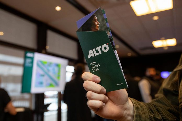 An attendee looks at an Alto brochure during an open house on the proposed high-speed rail network between Toronto and Quebec City held at the McDonnel Street Activity Centre in Peterborough on February 26, 2026. (Photo: Jordan Lyall / kawarthaNOW)