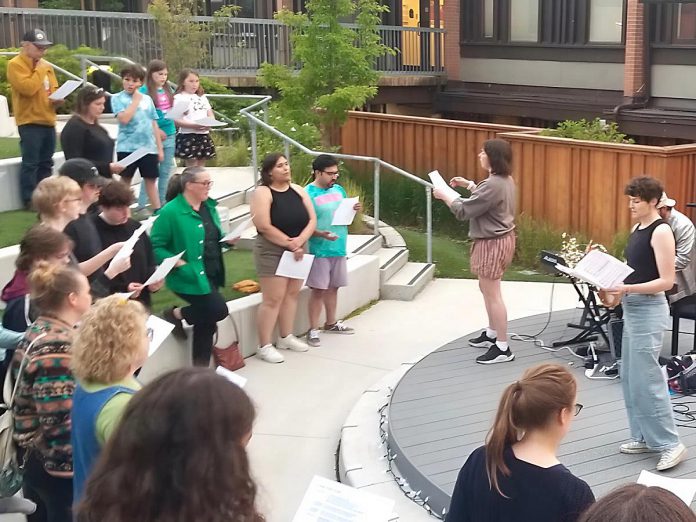 Volunteer-led organization Big Sing Nogojiwanong-Peterborough leads a community of singers of all ages and skill levels during the first free group choir event held on June 14, 2025 at the Jalynn Bennett Amphitheatre at Trent University's Traill College. The organization was formed to provide a free, inclusive, and informal space for community members to connect and engage in song. The group will be singing "Defying Gravity" on March 6, 2026 at 7 p.m. at Peterborough Square. (Photo courtesy of Big Sing Nogojiwanong-Peterborough)