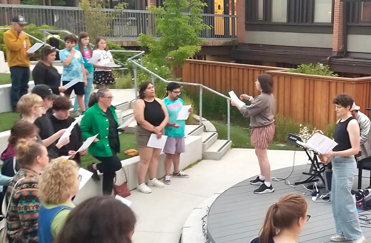 Big Sing Nogojiwanong-Peterborough invites community to raise their voices together Volunteer-led organization Big Sing Nogojiwanong-Peterborough leads a community of singers of all ages and skill levels during the first free group choir event held on June 14, 2025 at the Jalynn Bennett Amphitheatre at Trent University's Traill College. The organization was formed to provide a free, inclusive, and informal space for community members to connect and engage in song. The group will be singing "Defying Gravity" on March 6, 2026 at 7 p.m. at Peterborough Square. (Photo courtesy of Big Sing Nogojiwanong-Peterborough)