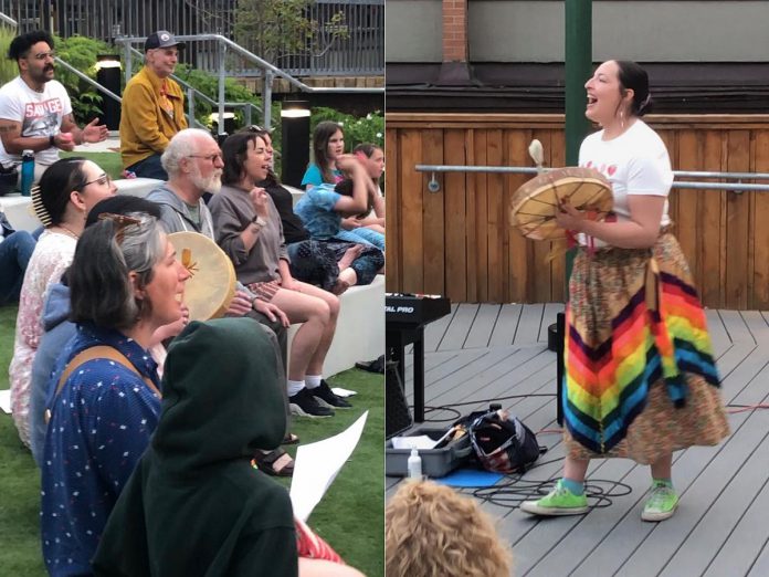 During the first Big Sing Nogojiwanong-Peterborough event on June 14, 2025 at the Jalynn Bennett Amphitheatre at Trent University's Traill College, Mshkiki Gitigaan Kwe led the group choir in a familiar and traditional water song. The musician and educator says there's a "power" in coming together in song that can be healing spiritually, emotionally, and physically. The group will be singing "Defying Gravity" on March 6, 2026 at 7 p.m. at Peterborough Square. (Photos courtesy of Big Sing Nogojiwanong-Peterborough)