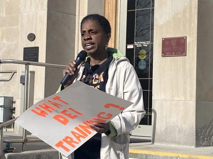 Charmaine Magumbe, chairperson of the Community Race Relations Committee of Peterborough and co-founder of the Afrocentric Awareness Network of Peterborough, addresses the crowd at Peterborough City Hall on April 28, 2025 during a protest of Mayor Jeff Leal's use of a racial slur while giving a guest lecture at Trent University. (Photo: Paul Rellinger / kawarthaNOW)