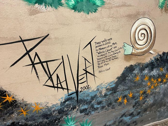 The giant mural created by Pat Calvert at Five Counties Children's Centre in Peterborough is deeply personal to her. As noted on the wall by the artist's signature, the mural is dedicated to Pat's mother, Winnie, who once worked at Five Counties. (Photo: Five Counties Children's Centre)