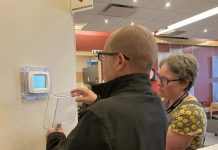 A representative of Morton Medical Centre in Douro-Dummer and GreenUP energy manager Clara Blakelock review optimal programmable thermostat settings during an energy efficiency walkthrough of the facility. GreenUP and the Peterborough DBIA are inviting small business owners a free breakfast open house on February 18, 2026 where energy experts will be available to answer questions. (Photo: Jackie Donaldson / GreenUP)