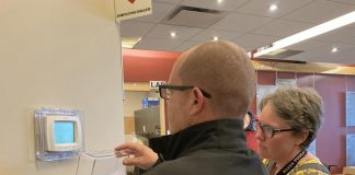 A representative of Morton Medical Centre in Douro-Dummer and GreenUP energy manager Clara Blakelock review optimal programmable thermostat settings during an energy efficiency walkthrough of the facility. GreenUP and the Peterborough DBIA are inviting small business owners a free breakfast open house on February 18, 2026 where energy experts will be available to answer questions. (Photo: Jackie Donaldson / GreenUP)