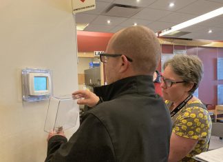 A representative of Morton Medical Centre in Douro-Dummer and GreenUP energy manager Clara Blakelock review optimal programmable thermostat settings during an energy efficiency walkthrough of the facility. GreenUP and the Peterborough DBIA are inviting small business owners to a free breakfast open house on February 18, 2026, where energy experts will be available to answer questions. (Photo: Jackie Donaldson / GreenUP)