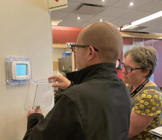 A representative of Morton Medical Centre in Douro-Dummer and GreenUP energy manager Clara Blakelock review optimal programmable thermostat settings during an energy efficiency walkthrough of the facility. GreenUP and the Peterborough DBIA are inviting small business owners to a free breakfast open house on February 18, 2026, where energy experts will be available to answer questions. (Photo: Jackie Donaldson / GreenUP)