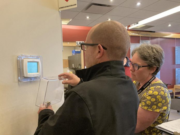 A representative of Morton Medical Centre in Douro-Dummer and GreenUP energy manager Clara Blakelock review optimal programmable thermostat settings during an energy efficiency walkthrough of the facility. GreenUP and the Peterborough DBIA are inviting small business owners to a free breakfast open house on February 18, 2026, where energy experts will be available to answer questions. (Photo: Jackie Donaldson / GreenUP)