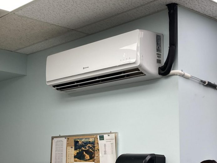 Heat pumps like this one at Charlotte Products are proving to be a smart heating and cooling option for small businesses looking to cut costs, improve comfort, and reduce emissions. GreenUP and the Peterborough DBIA are inviting small business owners to a free breakfast open house on February 18, 2026, where energy experts will be available to answer questions. (Photo: Clara Blakelock / GreenUP)