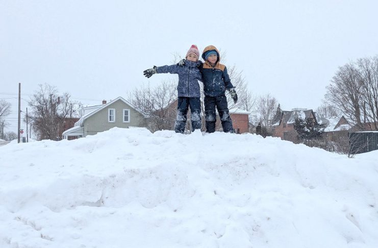Allowing children to engage in play is an important way kids make sense of the world and understand their own boundaries. Climbing a snow pile (in a safe location) during a winter walk to school is a great example of letting kids take reasonable risks and gain confidence through play. (Photo: Clara Blakelock / GreenUP)