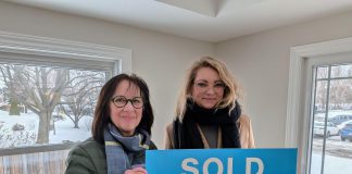 Habitat for Humanity Northumberland CEO Cathy Borowec with Anna, a single mother who was approved for the organization's affordable homeownership program in 2020, during a dedication and key ceremony on February 19, 2026 at a renovated home on Pinnacle Street South in Brighton. After six years, Anna and her daughter Emilia will soon be moving into the home, which was previously occupied by another Habitat family. (Photo courtesy of Habitat for Humanity Northumberland)