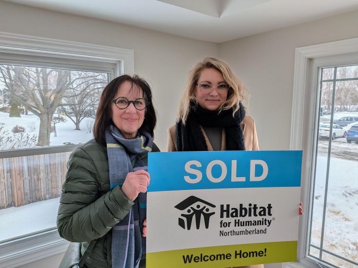 Habitat for Humanity Northumberland CEO Cathy Borowec with Anna, a single mother who was approved for the organization's affordable homeownership program in 2020, during a dedication and key ceremony on February 19, 2026 at a renovated home on Pinnacle Street South in Brighton. After six years, Anna and her daughter Emilia will soon be moving into the home, which was previously occupied by another Habitat family. (Photo courtesy of Habitat for Humanity Northumberland)