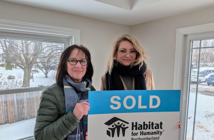 Habitat for Humanity Northumberland CEO Cathy Borowec with Anna, a single mother who was approved for the organization's affordable homeownership program in 2020, during a dedication and key ceremony on February 19, 2026 at a renovated home on Pinnacle Street South in Brighton. After six years, Anna and her daughter Emilia will soon be moving into the home, which was previously occupied by another Habitat family. (Photo courtesy of Habitat for Humanity Northumberland)