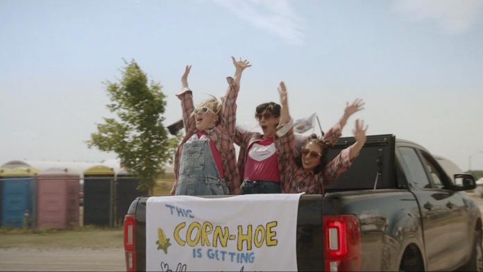 Nadine Djoury, Naomi Snieckus, and Paloma Nuñez in the Lindsay episode of "I'm Also Here," a new comedy anthology TV series produced by Firecracker Department and C'mon Mort Productions and premiering on Bell Fibe TV1 on February 12, 2026. Entirely written, directed, and starring women and non-binary artists, each episode of the six-part series explores a different Ontario small town, including Lindsay, Cobourg, and Bobcaygeon. The Lindsay episode, about an indecisive bride who finds herself forced to choose which friendships deserve a place beside her, was filmed at the Cornapalooza cornhole festival in Lindsay. (Screenshot courtesy of Firecracker Department)