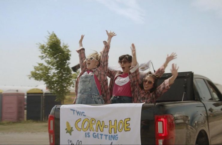 Nadine Djoury, Naomi Snieckus, and Paloma Nuñez in the Lindsay episode of "I'm Also Here," a new comedy anthology TV series produced by Firecracker Department and C'mon Mort Productions and premiering on Bell Fibe TV1 on February 12, 2026. Entirely written, directed, and starring women and non-binary artists, each episode of the six-part series explores a different Ontario small town, including Lindsay, Cobourg, and Bobcaygeon. The Lindsay episode, about an indecisive bride who finds herself forced to choose which friendships deserve a place beside her, was filmed at the Cornapalooza cornhole festival in Lindsay. (Screenshot courtesy of Firecracker Department)