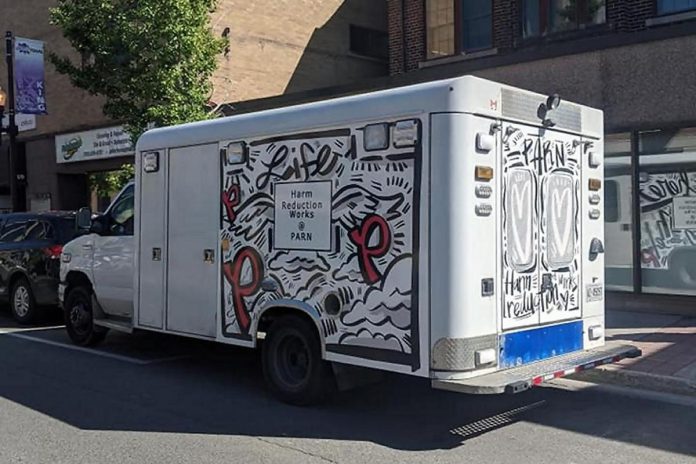 Since 2016, PARN has used a decommissioned ambulance — wrapped with a design by Peterborough illustrator and muralist Jason Wilkins — to provide harm reduction supplies and naloxone kits to drug users throughout the city and county of Peterborough, the City of Kawartha Lakes, Northumberland County, and Haliburton County. With 340,000 kilometres of wear and tear and high fuel costs and increasing maintenance needs, that vehicle is being retired for much more efficient options. (Photo courtesy of PARN)