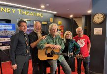 Joe Grant of LLF Lawyers, United Way Peterborough & District executive director Jim Russell, performer musician Mark Beatty, main stage emcee Ella Bates, and event co-founder and organizer Paul Rellinger during a media event at Showplace Performance Centre on February 12, 2026 to promote the Peterborough Performs VI: Musicians United To End Homelessness benefit concert on Thursday, February 26. (Photo: Adeline Murphy / United Way)